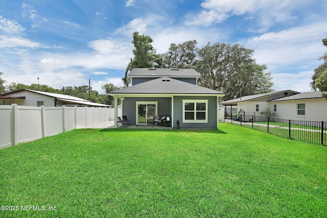 724 N Pine Ave, Green Cove Springs, FL 32043 - back of property with a fenced backyard, a shingled roof, and a patio