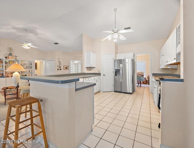 1121 Linkside Ct E, Atlantic Beach, FL 32233 - kitchen with stainless steel refrigerator with ice dispenser, a ceiling fan, a breakfast bar, light tile patterned floors, and lofted ceiling