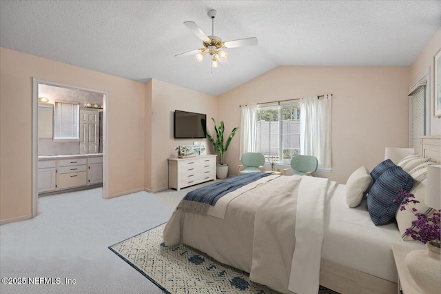 1121 Linkside Ct E, Atlantic Beach, FL 32233 - bedroom featuring light carpet, lofted ceiling, connected bathroom, ceiling fan, and a textured ceiling
