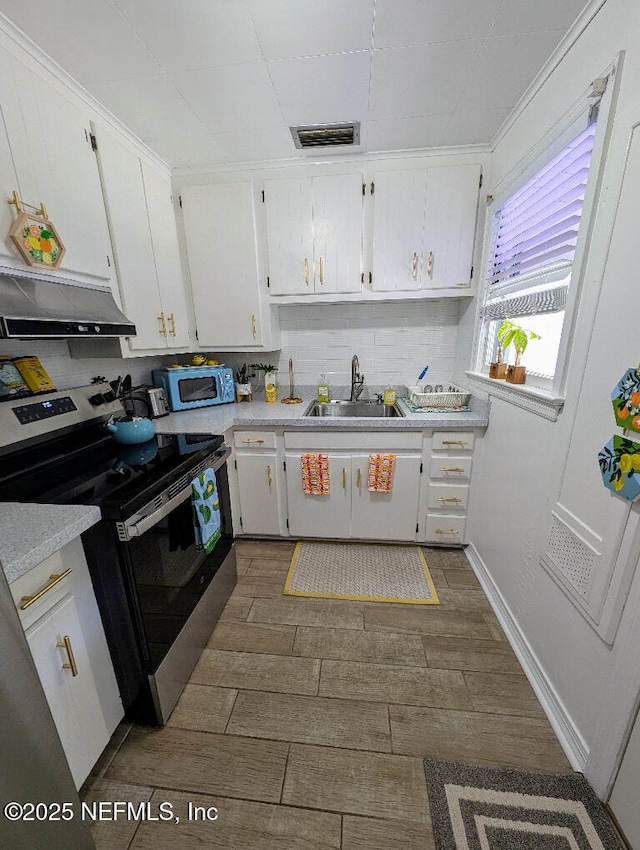 217 Covino Ave, Saint Augustine, FL 32084 - kitchen with stainless steel appliances, under cabinet range hood, and white cabinetry