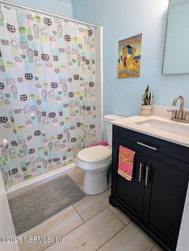 217 Covino Ave, Saint Augustine, FL 32084 - bathroom featuring vanity, curtained shower, and wood finished floors