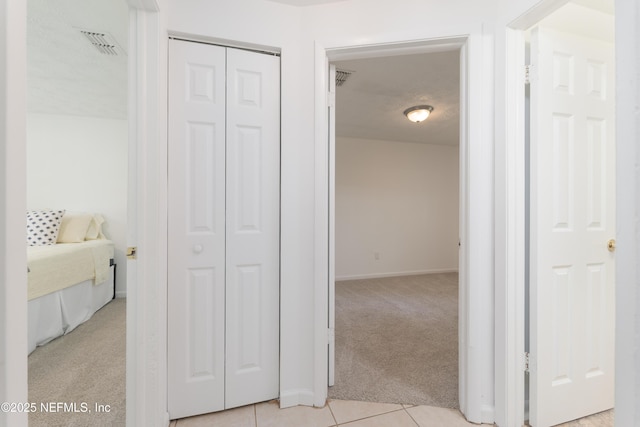 175 Evergreen Ln, Middleburg, FL 32068 - hallway with light colored carpet and light tile patterned floors