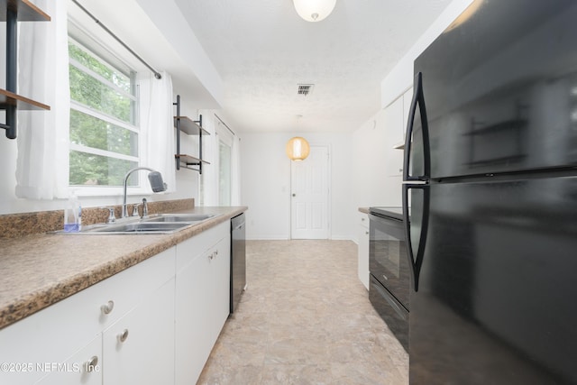 175 Evergreen Ln, Middleburg, FL 32068 - kitchen featuring black appliances, open shelves, white cabinetry, and a textured ceiling