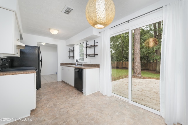 175 Evergreen Ln, Middleburg, FL 32068 - kitchen with dishwasher, white cabinets, open shelves, dark countertops, and wall chimney range hood