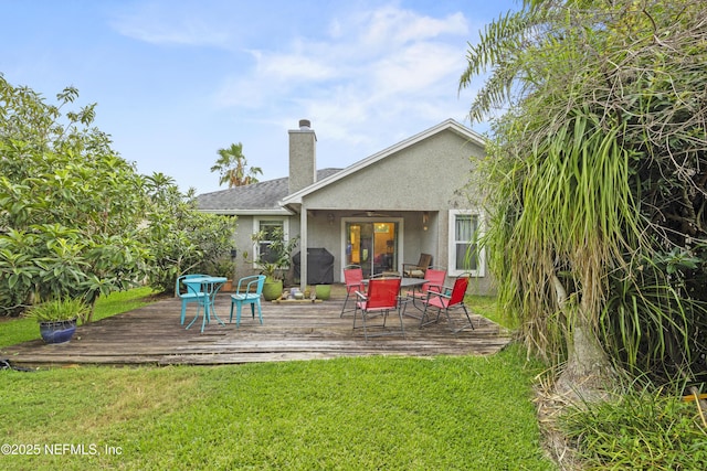 1419 Linkside Dr, Atlantic Beach, FL 32233 - back of property with stucco siding, a lawn, a chimney, and a deck