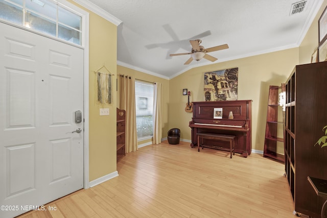 1419 Linkside Dr, Atlantic Beach, FL 32233 - foyer featuring ceiling fan, vaulted ceiling, crown molding, and light wood finished floors