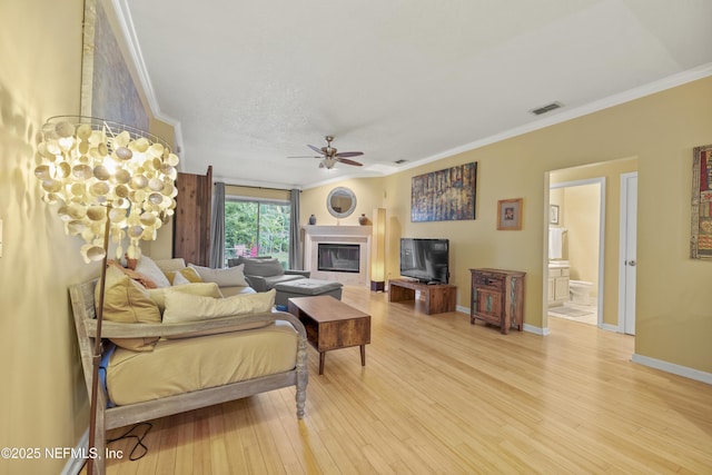 1419 Linkside Dr, Atlantic Beach, FL 32233 - living room with crown molding, a glass covered fireplace, light wood-style flooring, and a ceiling fan