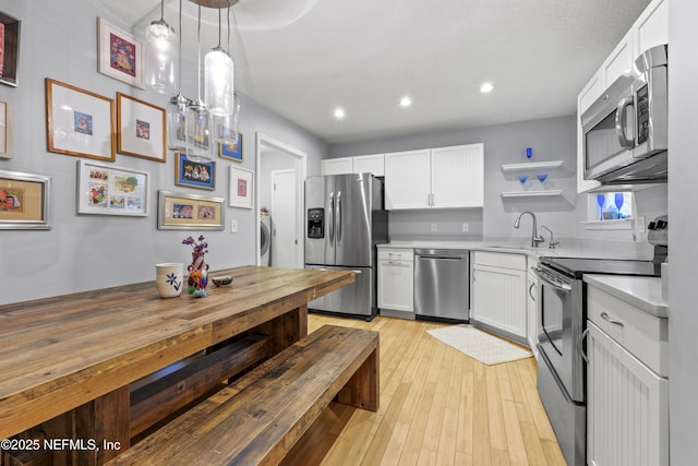1419 Linkside Dr, Atlantic Beach, FL 32233 - kitchen with stainless steel appliances, open shelves, light countertops, washer / clothes dryer, and recessed lighting