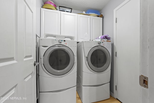 1419 Linkside Dr, Atlantic Beach, FL 32233 - washroom featuring cabinet space, washing machine and dryer, a textured ceiling, and light wood-type flooring