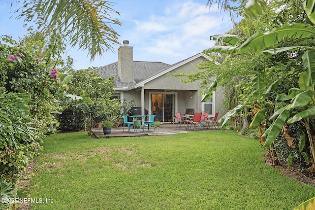 1419 Linkside Dr, Atlantic Beach, FL 32233 - back of property with a yard, stucco siding, a wooden deck, and a shingled roof