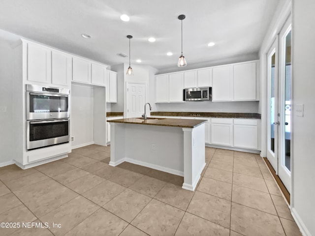 1090 Lauriston Dr, Saint Johns, FL 32259 - kitchen featuring stainless steel appliances, light tile patterned flooring, white cabinets, recessed lighting, and hanging light fixtures