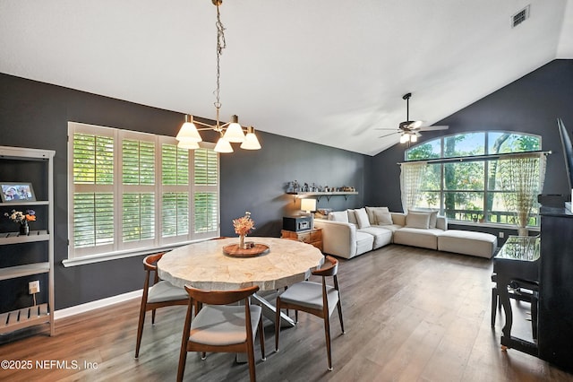14410 Pelican Bay Ct, Jacksonville, FL 32224 - dining room with lofted ceiling, wood finished floors, a ceiling fan, and a chandelier
