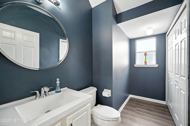 14410 Pelican Bay Ct, Jacksonville, FL 32224 - half bathroom with vanity, wood finished floors, and a textured ceiling