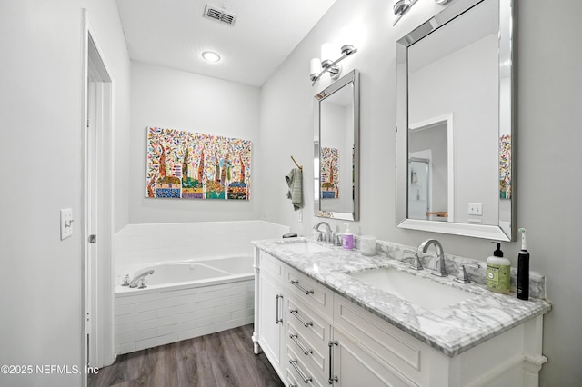 14410 Pelican Bay Ct, Jacksonville, FL 32224 - full bathroom with double vanity, wood finished floors, and a bath