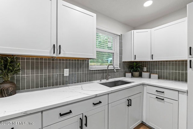 2571 Montreal St, Jacksonville, FL 32233 - kitchen with white cabinetry, tasteful backsplash, and light stone countertops