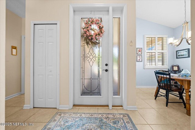 814 Copperhead Cir, Saint Augustine, FL 32092 - foyer with a chandelier, light tile patterned flooring, and lofted ceiling