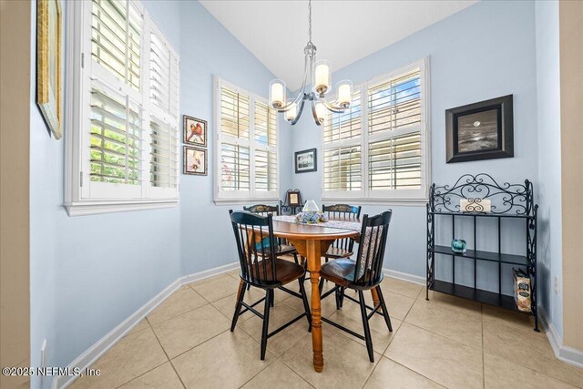 814 Copperhead Cir, Saint Augustine, FL 32092 - dining space with plenty of natural light, a chandelier, vaulted ceiling, and light tile patterned floors