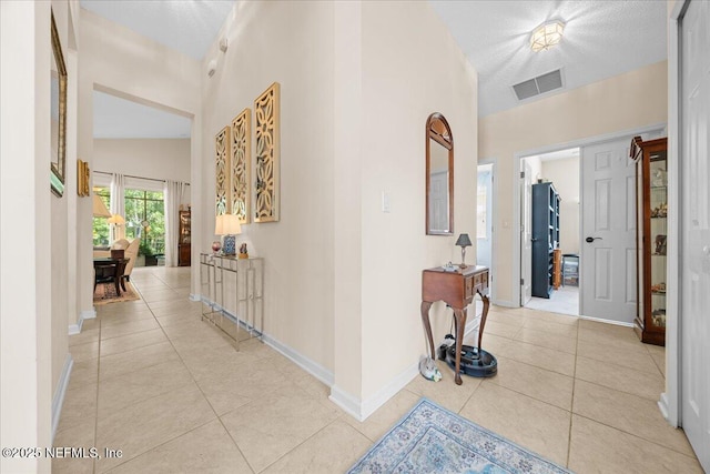 814 Copperhead Cir, Saint Augustine, FL 32092 - hallway with light tile patterned flooring and a towering ceiling