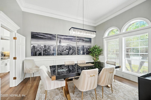 24237 Marsh Landing Pkwy, Ponte Vedra Beach, FL 32082 - dining space featuring crown molding, wood finished floors, and a chandelier