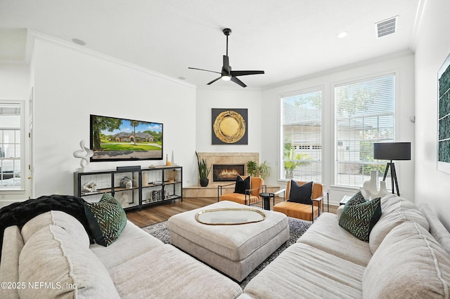 24237 Marsh Landing Pkwy, Ponte Vedra Beach, FL 32082 - living room featuring crown molding, a ceiling fan, wood finished floors, a tiled fireplace, and recessed lighting