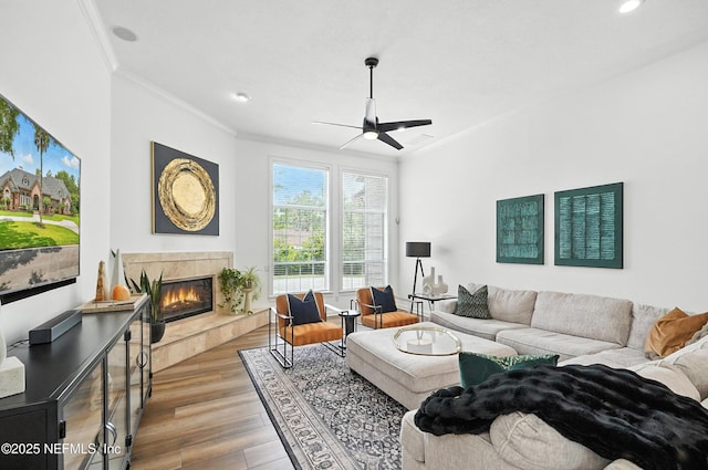 24237 Marsh Landing Pkwy, Ponte Vedra Beach, FL 32082 - living area featuring ornamental molding, light wood-style flooring, a tile fireplace, ceiling fan, and recessed lighting