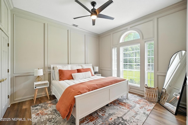 24237 Marsh Landing Pkwy, Ponte Vedra Beach, FL 32082 - bedroom with a decorative wall, wood finished floors, and a ceiling fan