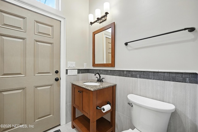 24237 Marsh Landing Pkwy, Ponte Vedra Beach, FL 32082 - half bathroom with vanity, wainscoting, and tile walls