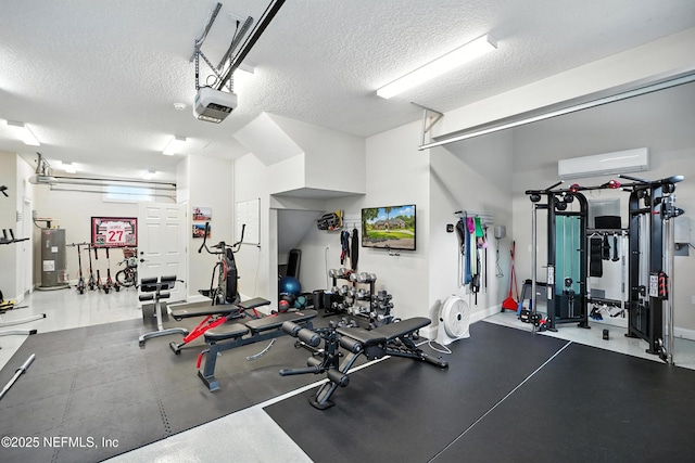 24237 Marsh Landing Pkwy, Ponte Vedra Beach, FL 32082 - exercise room featuring a garage, a textured ceiling, a wall mounted air conditioner, and water heater