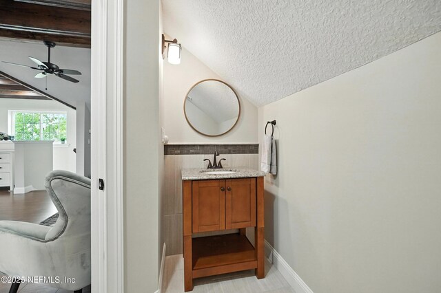 24237 Marsh Landing Pkwy, Ponte Vedra Beach, FL 32082 - bathroom with a textured ceiling, lofted ceiling, vanity, and a ceiling fan