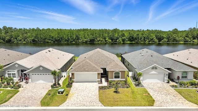 29 Lagoon Way, Palm Coast, FL 32137 - ranch-style house with a water view, decorative driveway, and stucco siding
