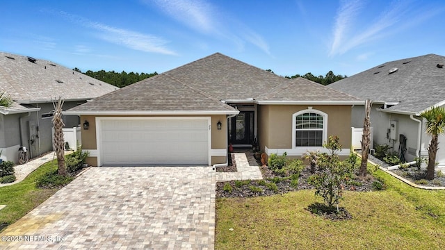 29 Lagoon Way, Palm Coast, FL 32137 - ranch-style home featuring stucco siding, a garage, decorative driveway, a shingled roof, and a front yard