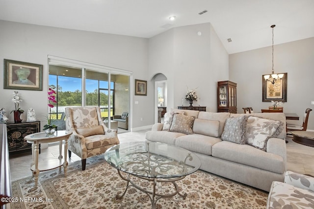29 Lagoon Way, Palm Coast, FL 32137 - living room with a chandelier, arched walkways, and high vaulted ceiling