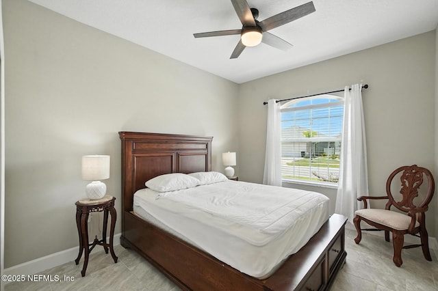 29 Lagoon Way, Palm Coast, FL 32137 - bedroom with baseboards and a ceiling fan