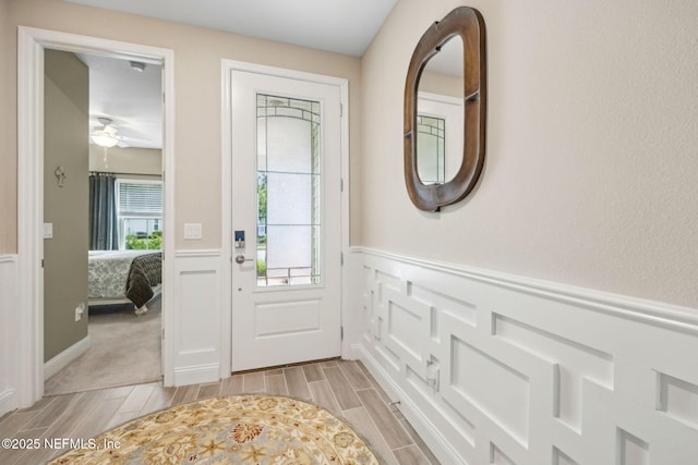 3146 Villa Vera Ct, Jacksonville, FL 32246 - foyer with wainscoting, wood tiled floors, a decorative wall, and ceiling fan