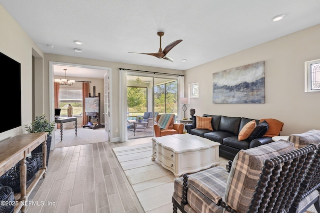 3146 Villa Vera Ct, Jacksonville, FL 32246 - living area with light wood finished floors, a chandelier, a ceiling fan, and recessed lighting