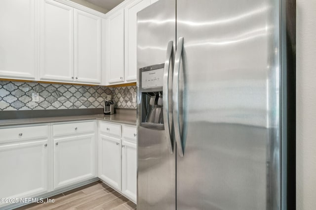 3146 Villa Vera Ct, Jacksonville, FL 32246 - kitchen featuring stainless steel fridge with ice dispenser, tasteful backsplash, white cabinetry, and light wood finished floors