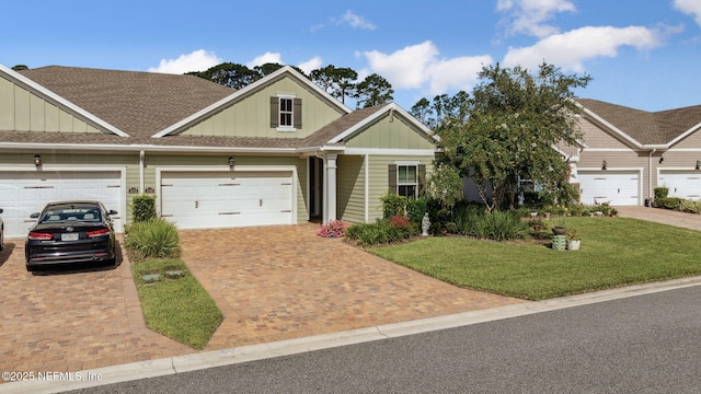 3146 Villa Vera Ct, Jacksonville, FL 32246 - view of front of property with board and batten siding, decorative driveway, a front lawn, and roof with shingles