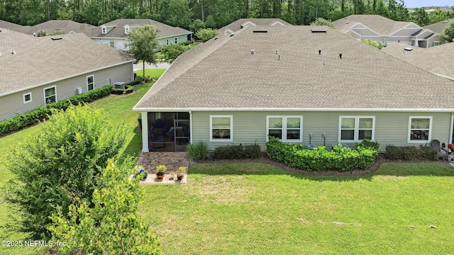 3146 Villa Vera Ct, Jacksonville, FL 32246 - rear view of house featuring a sunroom, a lawn, and roof with shingles