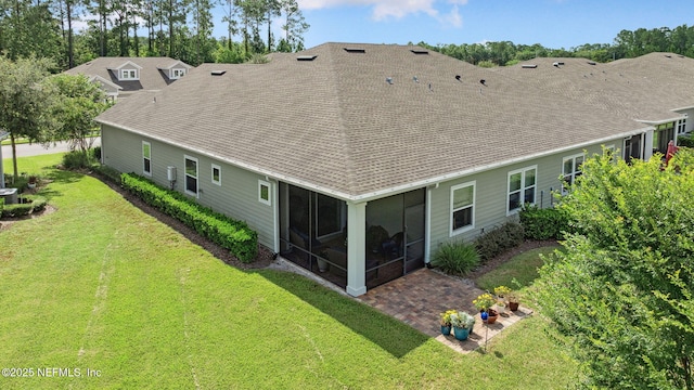 3146 Villa Vera Ct, Jacksonville, FL 32246 - back of house with a sunroom, roof with shingles, a lawn, and a patio area