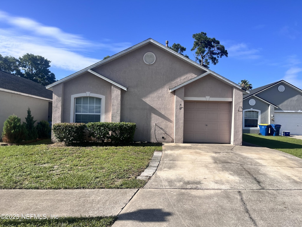 7234 Lawn Tennis Ln, Jacksonville, FL 32277 - ranch-style house featuring stucco siding, a front yard, and driveway
