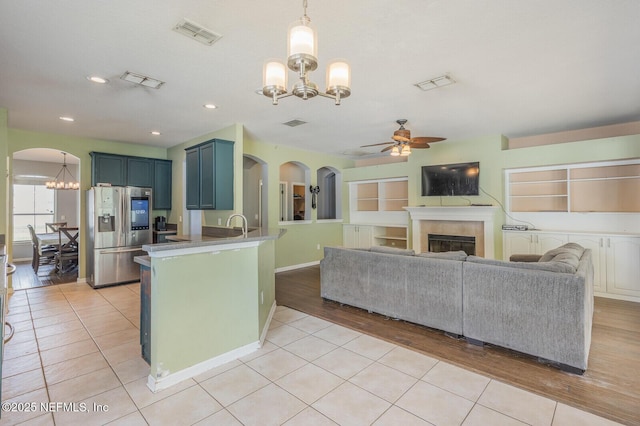 3350 Silverado Cir, Green Cove Springs, FL 32043 - kitchen featuring stainless steel refrigerator with ice dispenser, a chandelier, ceiling fan, a peninsula, and arched walkways