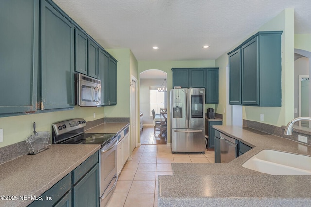 3350 Silverado Cir, Green Cove Springs, FL 32043 - kitchen featuring appliances with stainless steel finishes, arched walkways, light tile patterned flooring, and recessed lighting