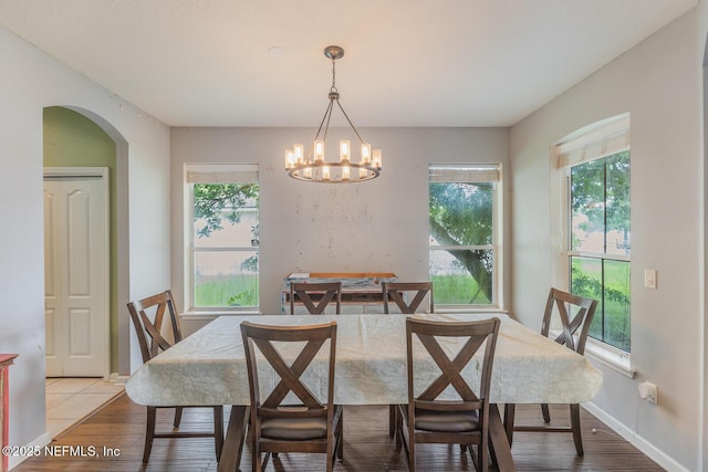 3350 Silverado Cir, Green Cove Springs, FL 32043 - dining room featuring arched walkways, a chandelier, and light wood finished floors