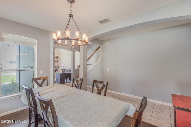 3350 Silverado Cir, Green Cove Springs, FL 32043 - tiled dining space with arched walkways and a chandelier