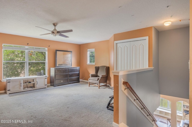3350 Silverado Cir, Green Cove Springs, FL 32043 - living area featuring an upstairs landing, carpet floors, and a ceiling fan