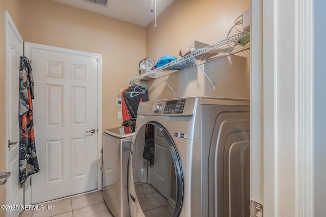 3350 Silverado Cir, Green Cove Springs, FL 32043 - laundry room featuring washing machine and clothes dryer and light tile patterned floors