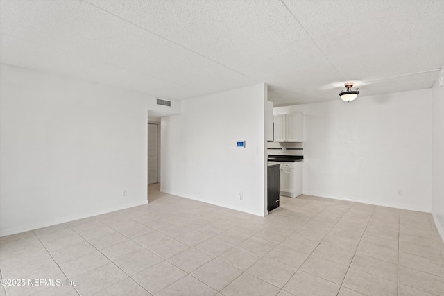 355 Monument Rd Unit 15D1, Jacksonville, FL 32225 - unfurnished living room with a textured ceiling and light tile patterned floors