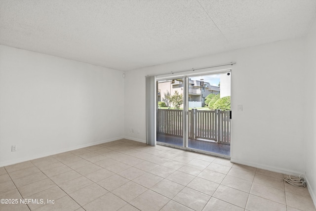 355 Monument Rd Unit 15D1, Jacksonville, FL 32225 - spare room featuring a textured ceiling and light tile patterned floors