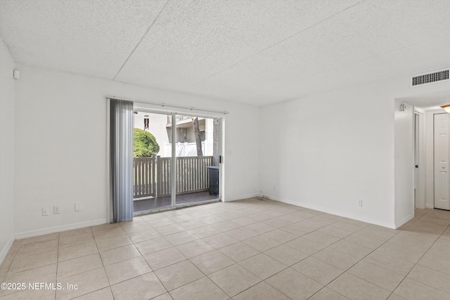 355 Monument Rd Unit 15D1, Jacksonville, FL 32225 - spare room with a textured ceiling and light tile patterned floors