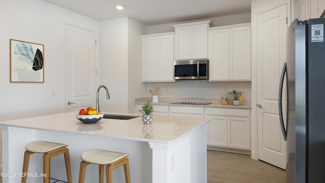 324 Higgins Loop, Saint Augustine, FL 32092 - kitchen featuring stainless steel appliances, recessed lighting, light wood-style floors, white cabinets, and a kitchen island with sink
